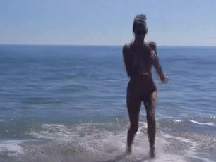 Mind-blowing stunner in teeny bathing suit on beach in